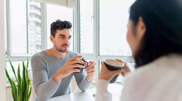 Two colleagues maintain eye contact during a meeting.